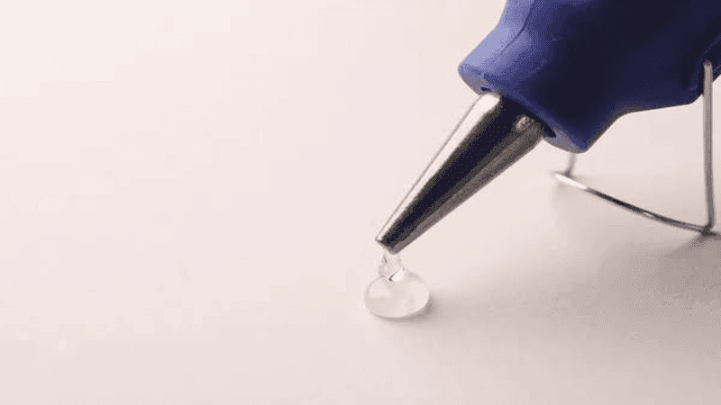 Blue hot melt glue gun melts hot melt glue