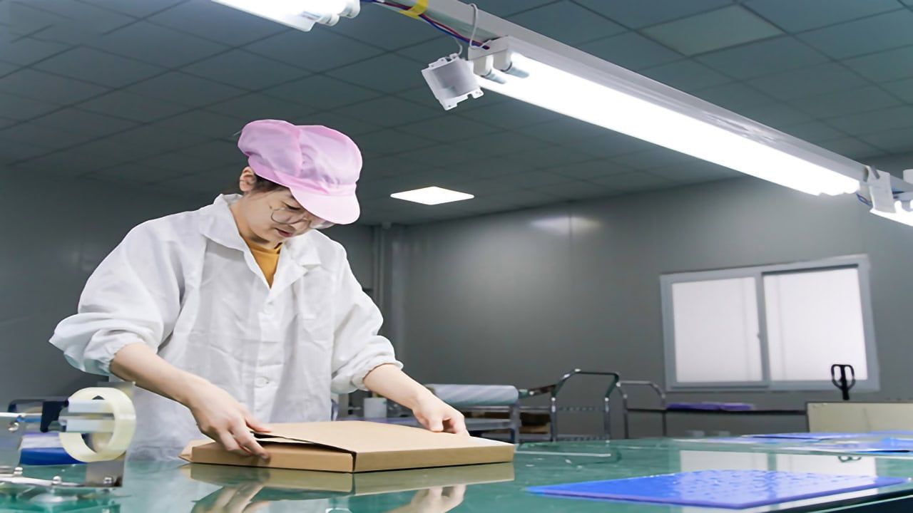 Factory employees packing thermal pads